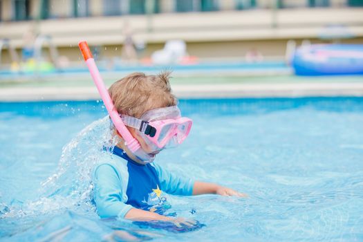 boy playing in a pool of water during the summer