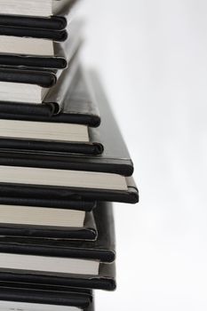 A stack of black, equal books from the side