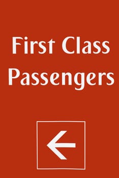 First class passenger sign at airport on a red background, signified priority, wealth, and power.