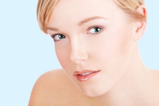 Closeup portrait of beautiful clean face of young woman