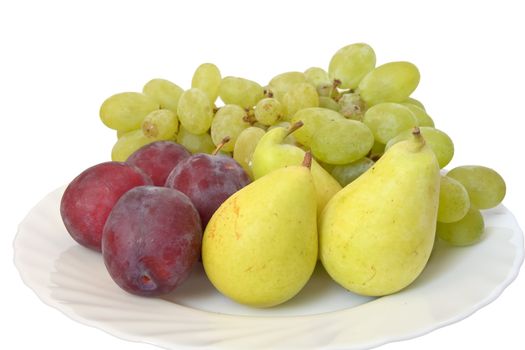 plate with plums, grapes and pears isolated on white background