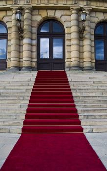 beautiful red carpet leading up old steps 