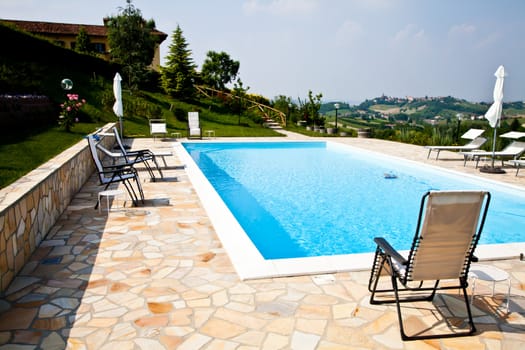 Swimming pool of an Italian beauty farm in the middle vineyards, Monferrato area, Piemonte region.
