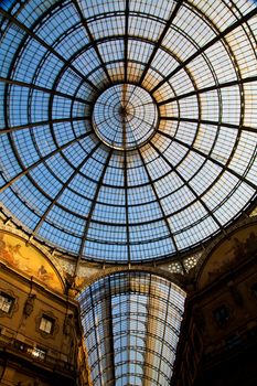 The Galleria Vittorio Emanuele II is a covered double arcade formed of two glass-vaulted arcades at right angles intersecting in an octagon, prominently sited on the northern side of the Piazza del Duomo in Milan.