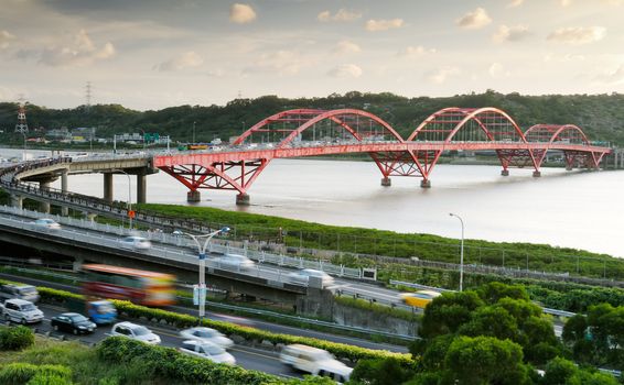 It is a beautiful cityscape of bridge and cars.
