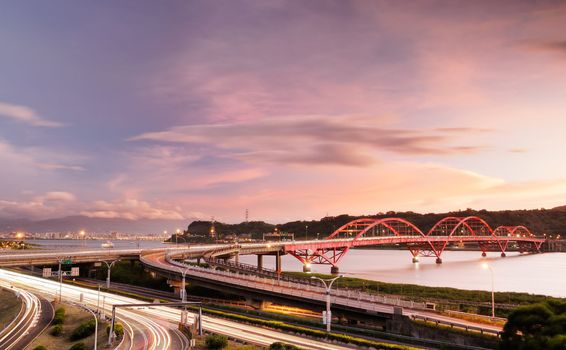 It is a cityscape of interchange with cars light.