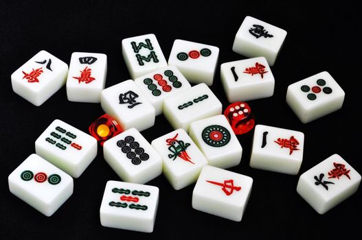 Chinese mahjong tiles and dices on a black background