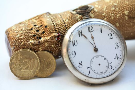 A champagne bottle, a vintage pocket watch and two euro coins. Perfect New Years greeting card