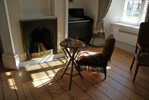 Interior of a room with a fireplace and an armchair