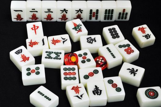 Chinese mahjong tiles and dices on a black background