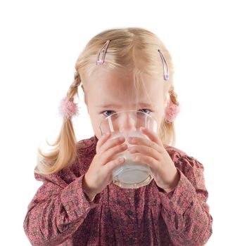 Shot of little girl in studio drinking milk