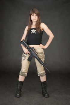 The young terrible woman in trousers and boots up in arms