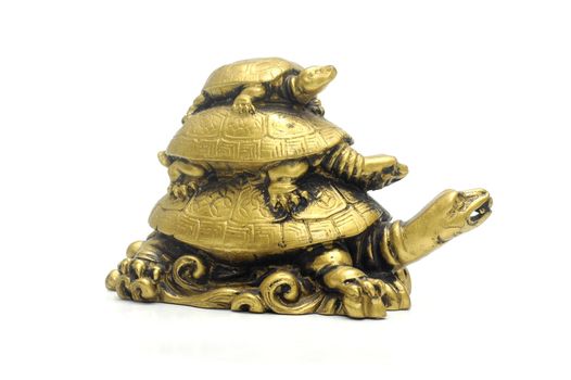 Statuette of three bronze turtles one over another