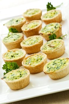 Plate of many mini bite size quiche appetizers
