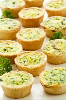 Plate of many mini bite size quiche appetizers