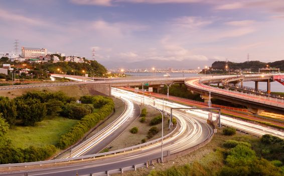 It is a cityscape of interchange with cars light.