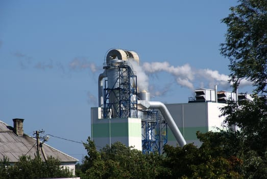 Pipes of a factory on a background of the blue sky