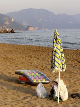 Sunshade and other beach equipment at sandy beach.