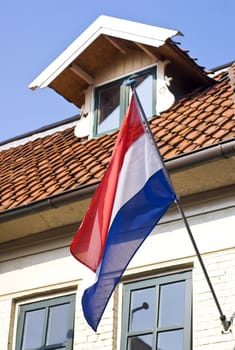 Dutch house with a waving dutch flag.