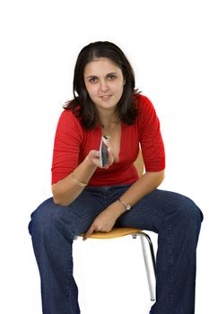 Young lady sitting with a television remote control in her hand isolated on white