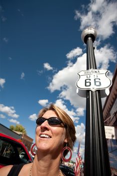 Woman on side of route in front of Route 66 sign