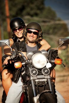 Man and Woman riding on vintage motorcyle