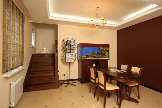 
Interior of a modern room with a table, chairs and a ladder on the second floor
