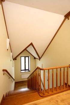 Wooden ladder downwards, a handrail from a file of a tree and a ceiling finished with a tree
