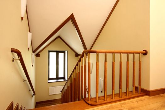 Wooden ladder downwards, a handrail from a file of a tree and a ceiling finished with a tree
