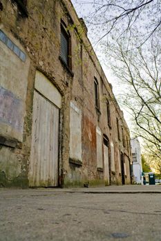 A grungy, abandoned brick building on the outskirts of town.