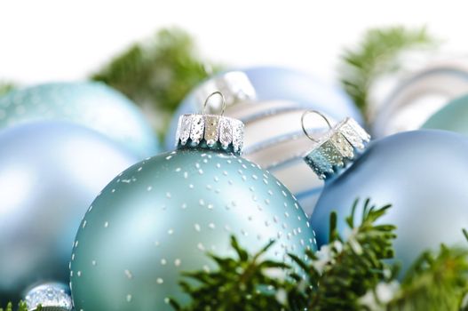 Many Christmas decorations laying in pine branches
