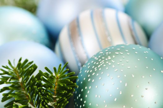 Many Christmas decorations laying in pine branches
