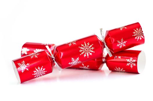 Two red Christmas crackers isolated on white