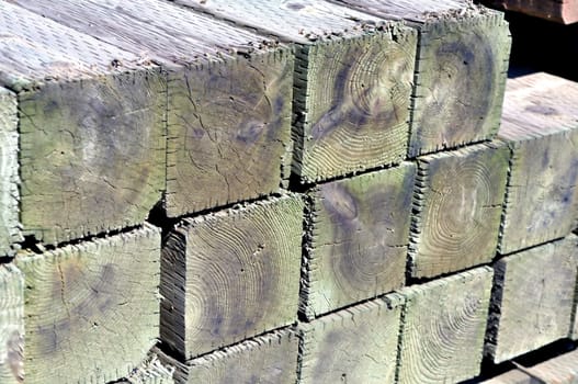 Stack of wooden fence posts waiting for delivery