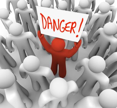 A red person stands out in a crowd holding a sign that reads Danger to warn and alert other people to a risk, hazard or other dangerous condition