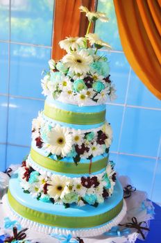 Layered wedding cake against window