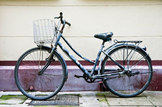 Old Chinese bicycle park on sidewalk along a narrow street