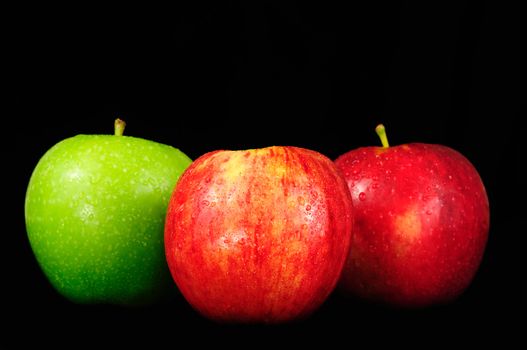 Different varieties of apples arranged over black background