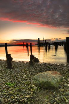 Striking image of fiery red sunset reflected across the deserted bay - HDR photo