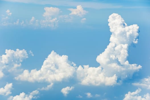Fluffy clouds shot from airplane window