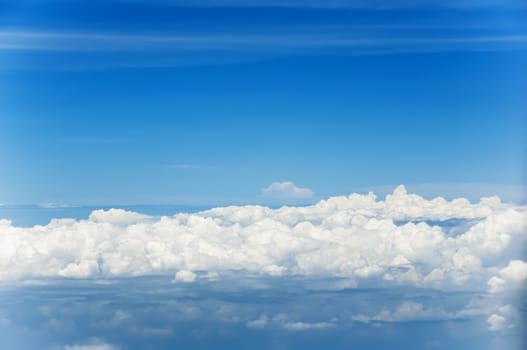 Fluffy clouds shot from airplane window