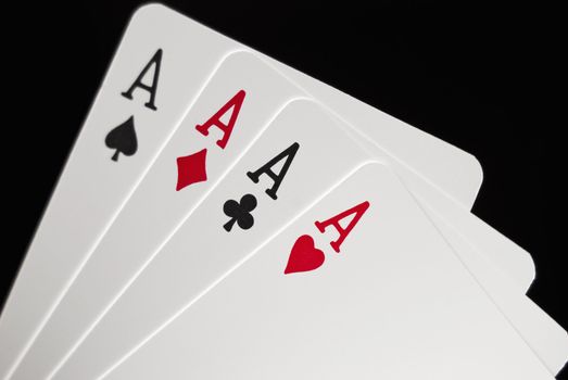 Four Aces against black background