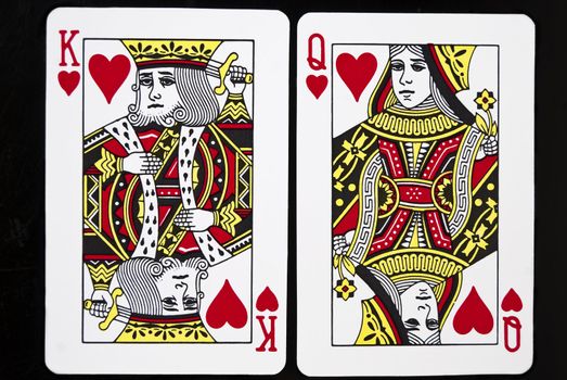 King and Queen of Hearts against black background