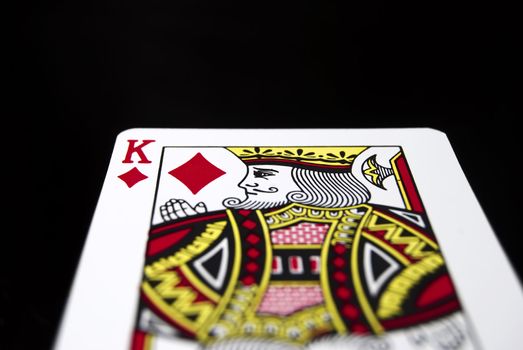 King of Diamonds against black background