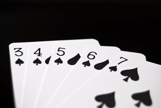 Straight cards against black background