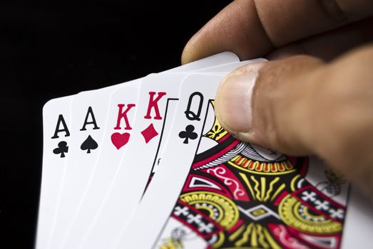 Two pairs held by hand against black background