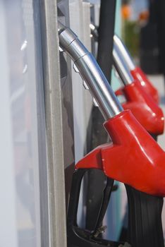 Red gas nozzles in a petrol station