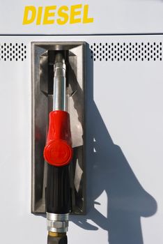 Red gas nozzle in a petrol station