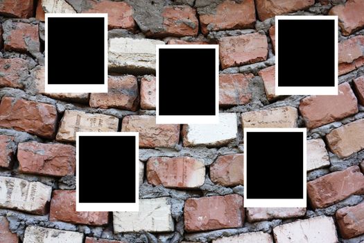 set of five old blank polaroids frames lying on a brick surface 
