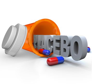 An open prescription medicine bottle on its side and spilled, with the word Placebo indicating it is not real medicine and rather inactive capsules to be given to a control group in a medical study